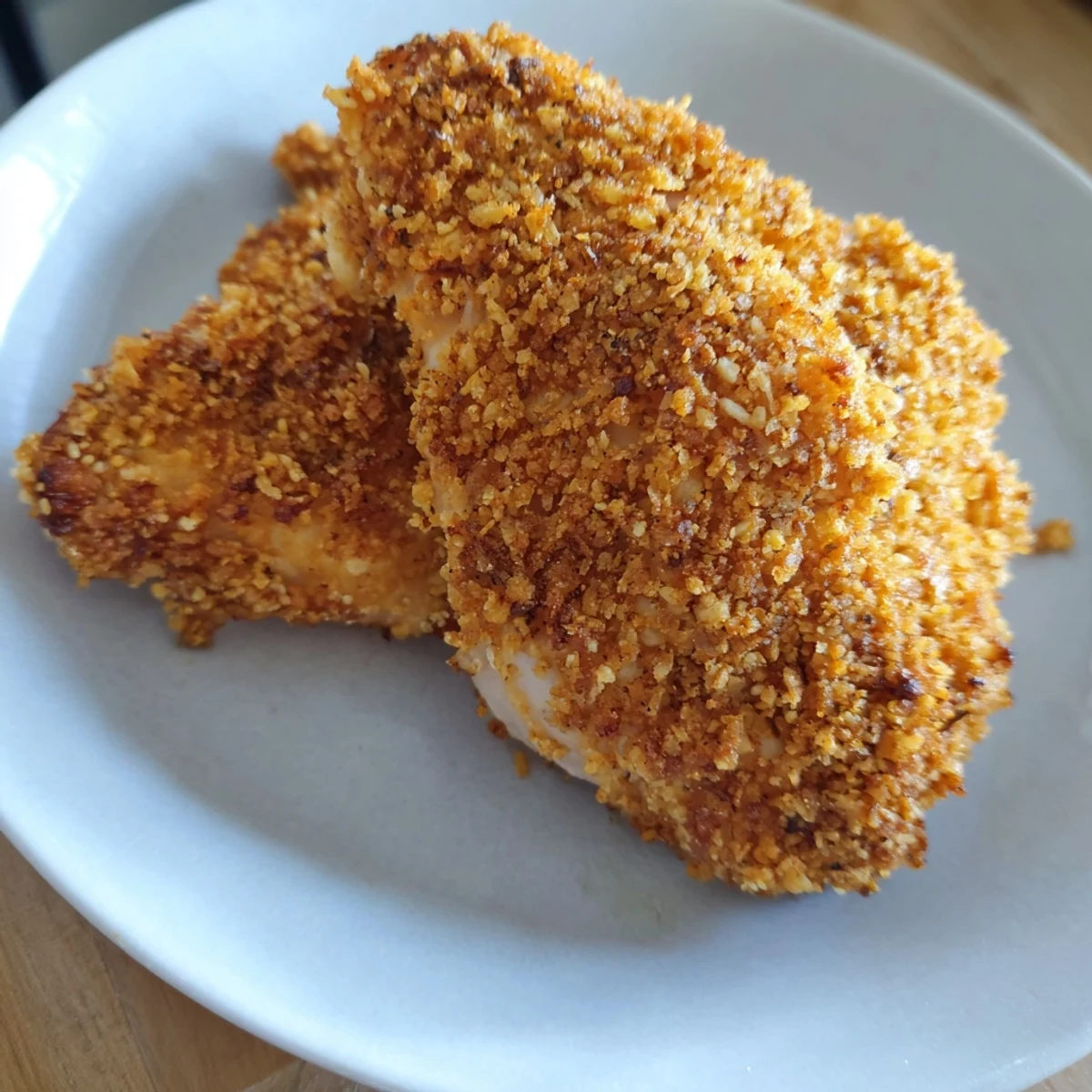 Close-up of perfectly fried crispy chicken with a flavorful, seasoned, crunchy coating.