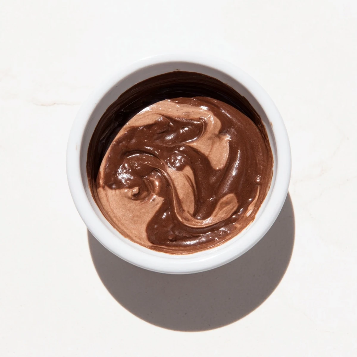 Silky-smooth chocolate pudding topped with whipped cream, the perfect easy dessert to enjoy.