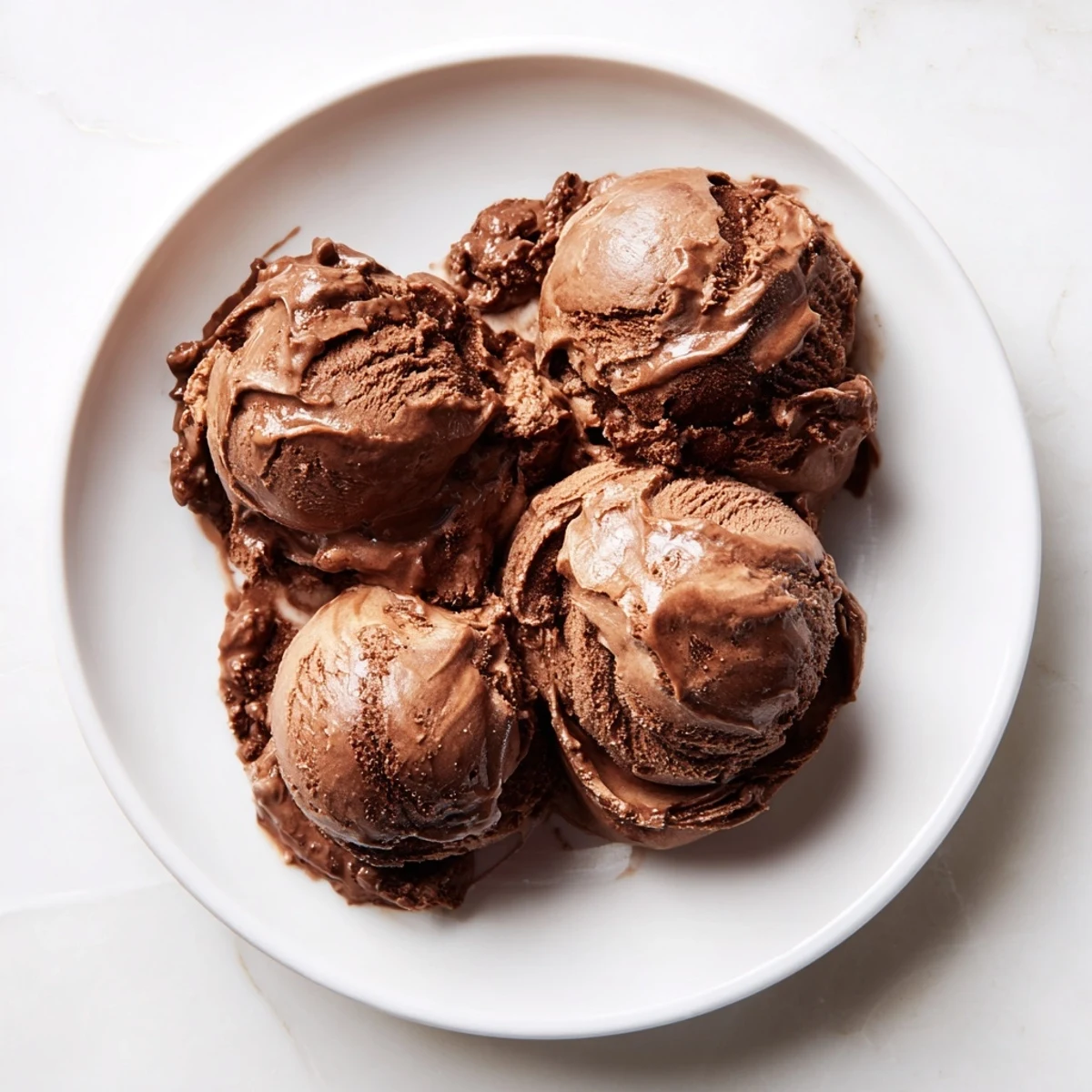 Homemade chocolate ice cream, beautifully presented, showcasing a velvety smooth texture and rich cocoa taste.