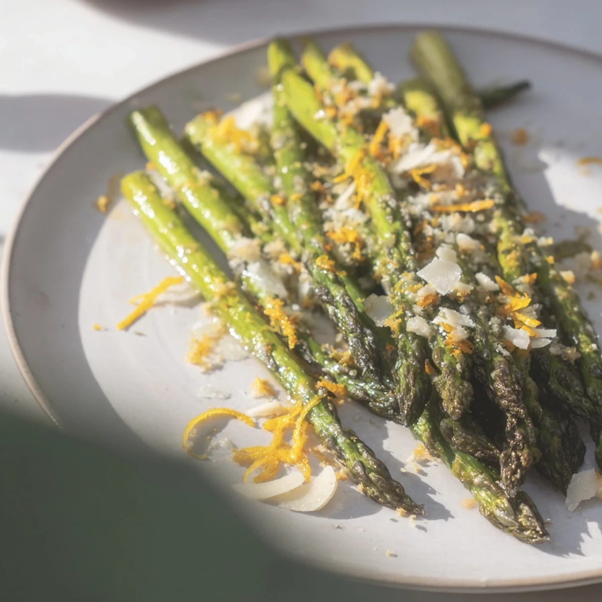 A close-up of crispy Garlic Parmesan Roasted Asparagus, perfect with a sprinkle of fresh parsley.
