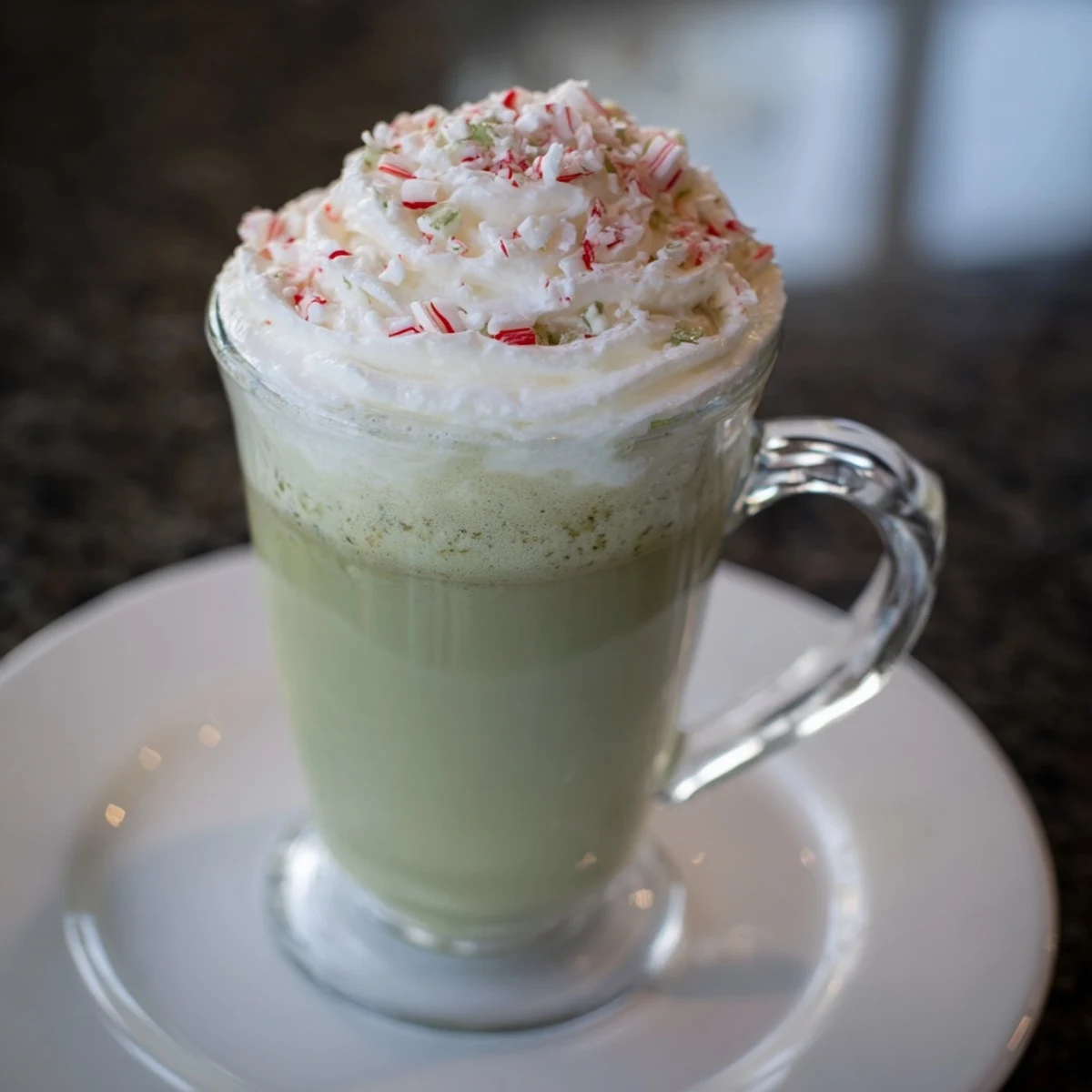 A close-up of a cozy, warm peppermint tea latte with frothy milk, perfect for a chilly day.