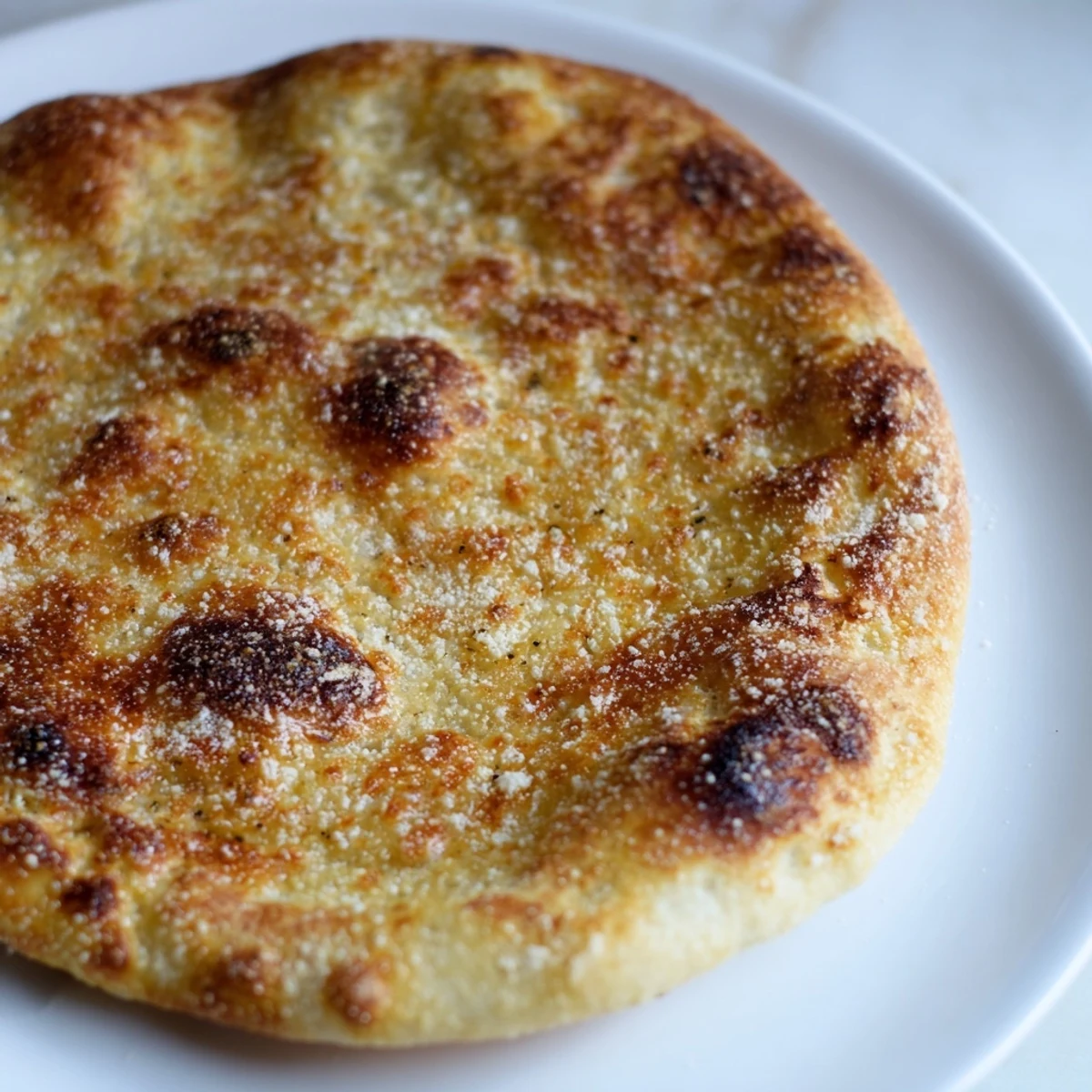Close-up of a perfectly baked, golden-brown crispy pizza crust, promising delicious flavor and crunch.