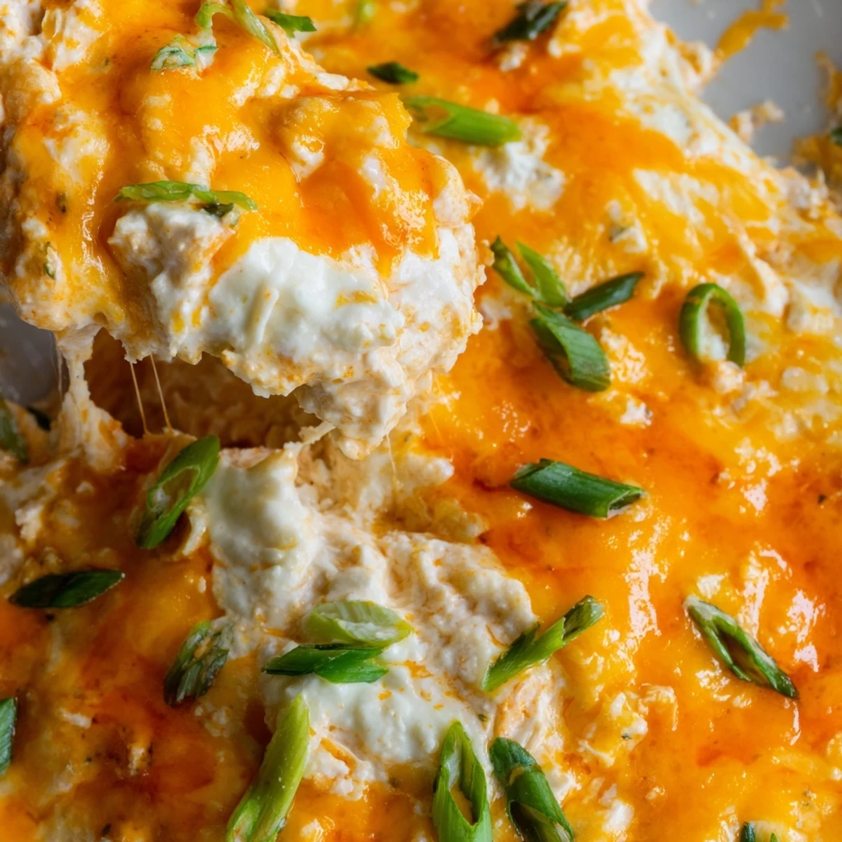Easy-to-make, creamy Spicy Buffalo Chicken Dip, ready for dipping on game day with crispy chips.
