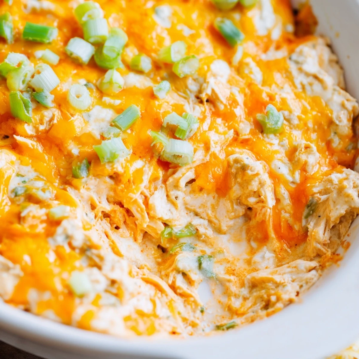 Flavorful Spicy Buffalo Chicken Dip with bubbly melted cheese, served hot with tortilla chips.
