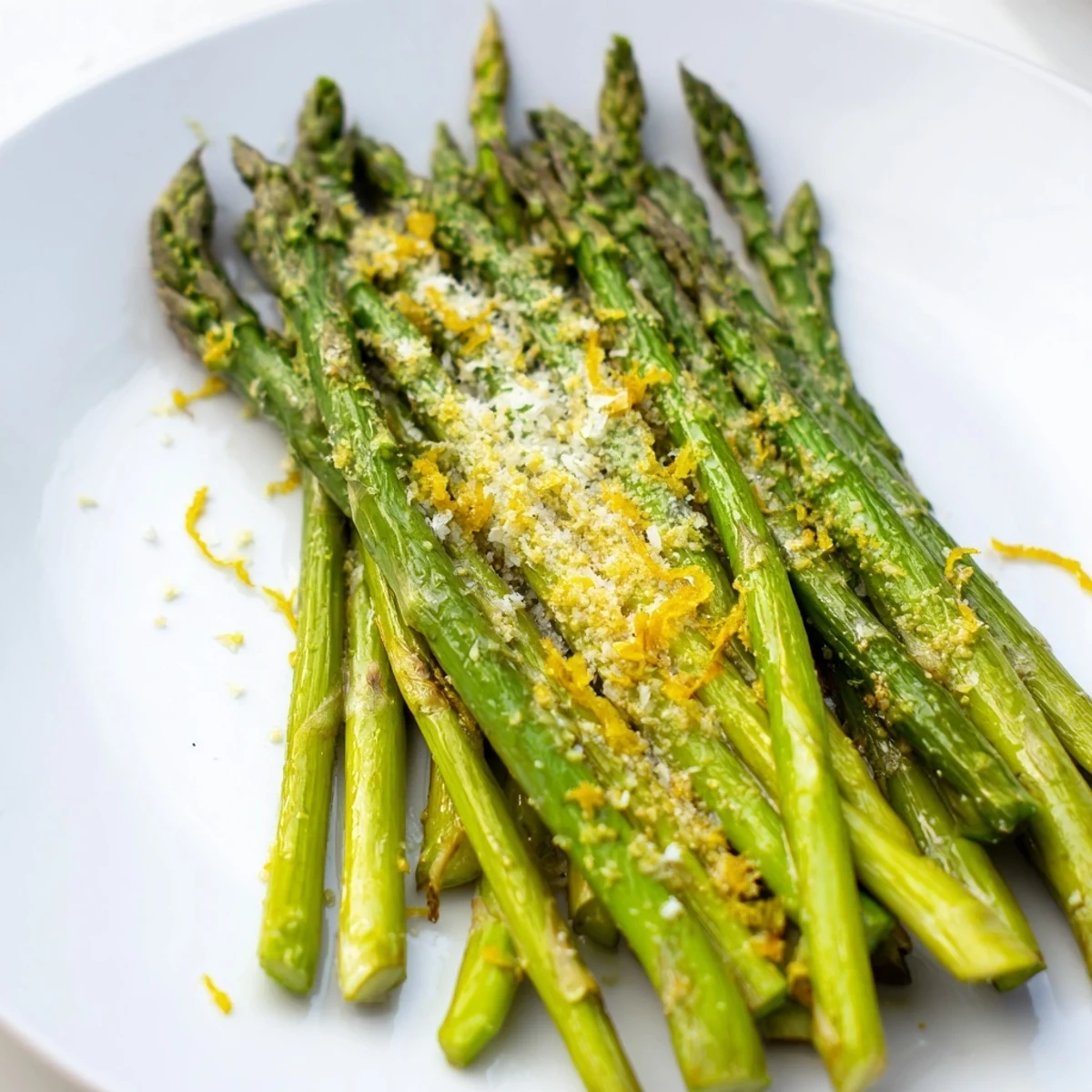 Roasted Lemon Garlic Asparagus with Parmesan, bright green asparagus with golden-brown tips and a cheesy topping.