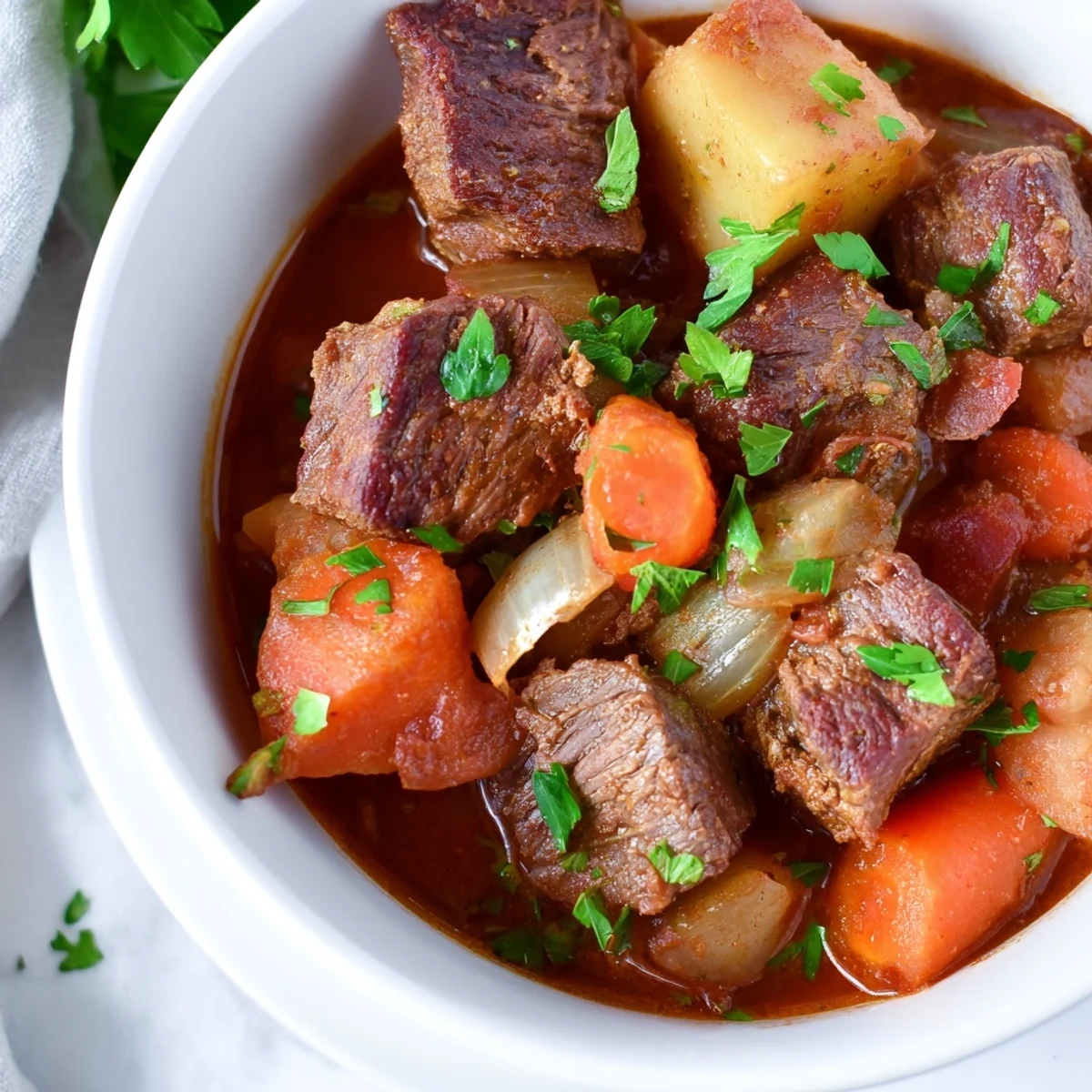 Slow Cooker Beef Stew with Potatoes and Carrots in a slow cooker, showing savory broth, soft carrots, and tender beef pieces.