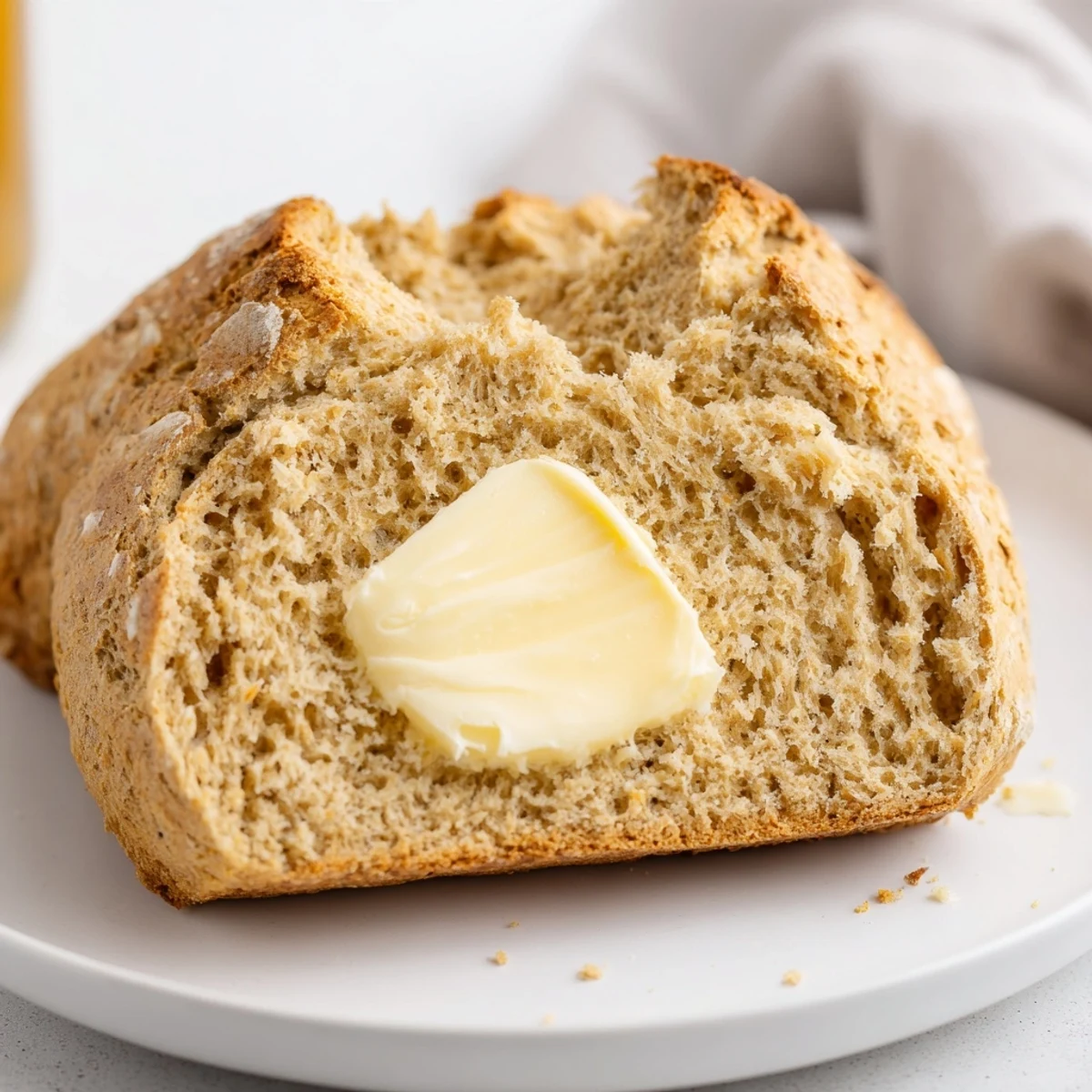 Rustic Soda Bread with Irish Butter, warm golden crust, tender crumb ready to slice.